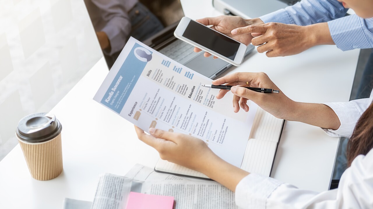 Recruiters looking through resumes