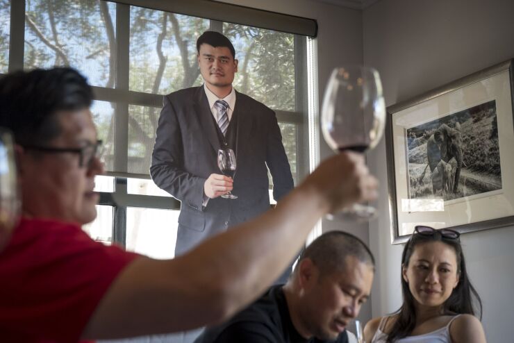 Patrons taste wine inside the Yao Family Wines tasting room in St. Helena, California.