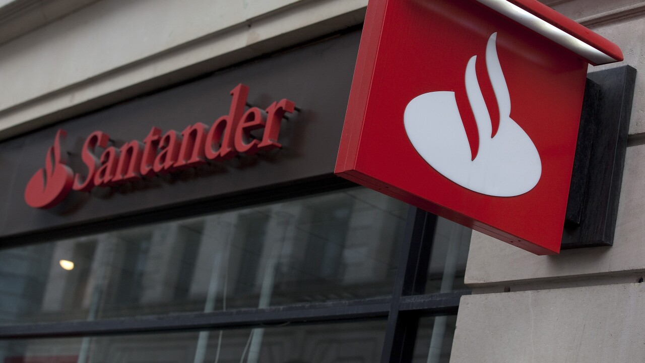 A sign hangs outside a Banco Santander bank branch.