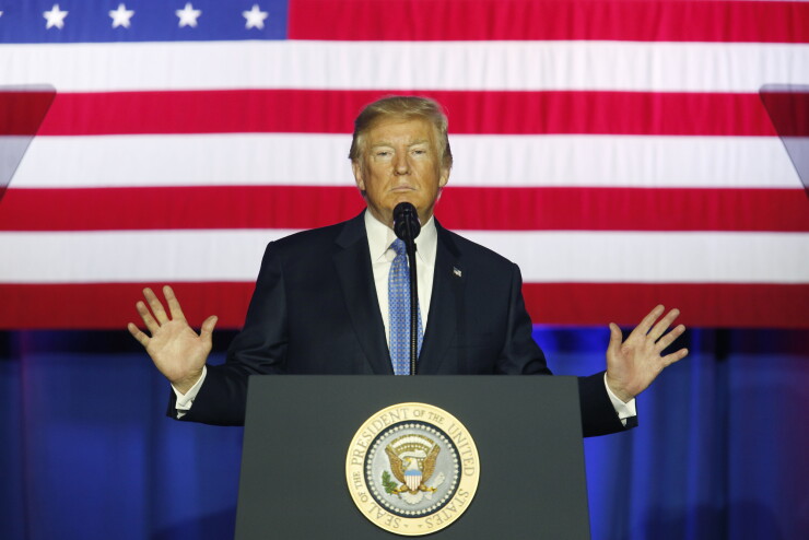 Donald Trump hands spread in front of American Flag