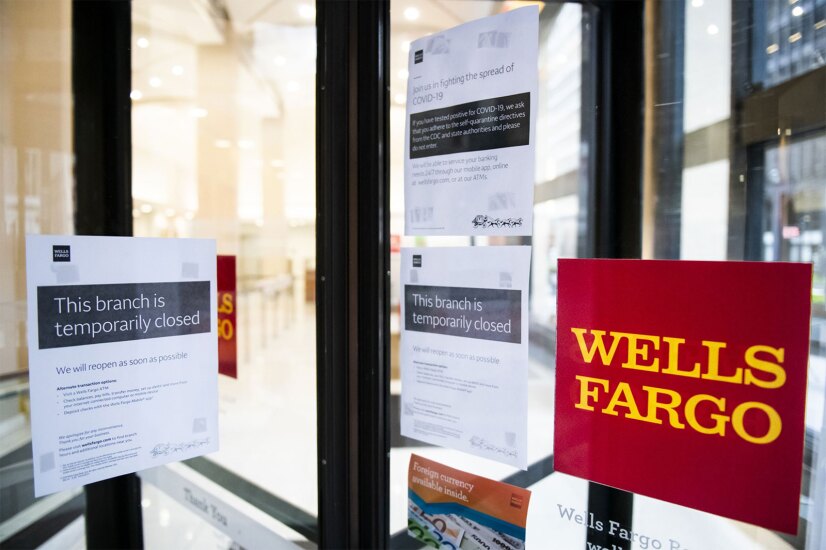 A temporarily closed sign is displayed in the window of a Wells Fargo branch in an effort to stem the spread of COVID-19 in New York on April 10, 2020.