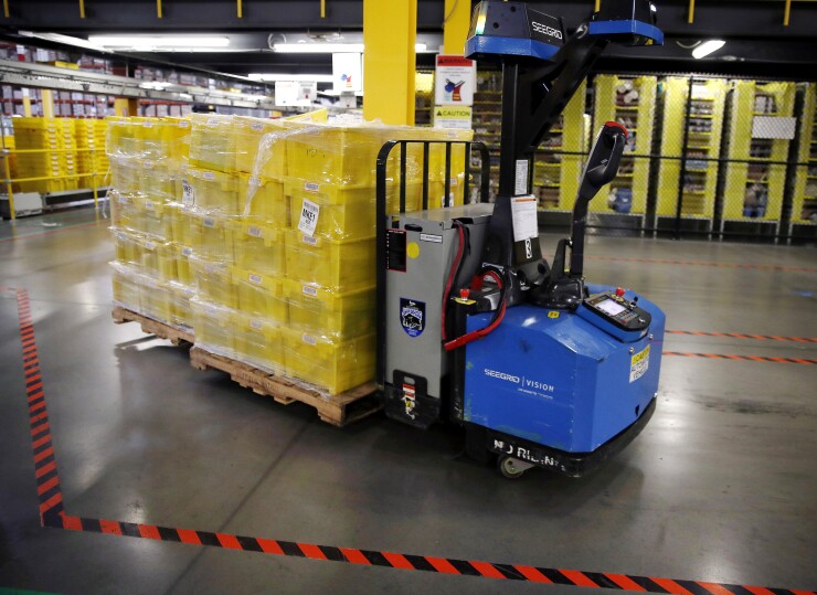 An automated cart moves bins of products through the Amazon.com fulfillment center in Kenosha, Wisconsin, U.S.