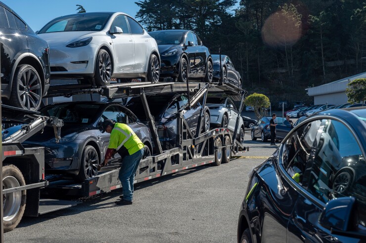 Vehicles are offloaded at a Tesla store in Colma, California