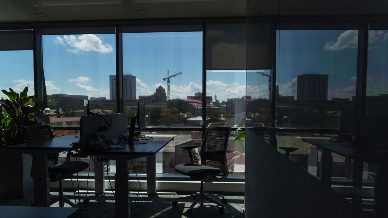 Sunlight illuminates an empty office as employees work from home, at the UiPath Inc. offices in Bucharest, Romania, on Friday, May 14, 2021. Started in an apartment in Romania with 10 people in 2005, UiPath now has a presence in close to 30 countries, and raised $1.3 billion initial public offering last month. Photographer: Andrei Pungovschi/Bloomberg