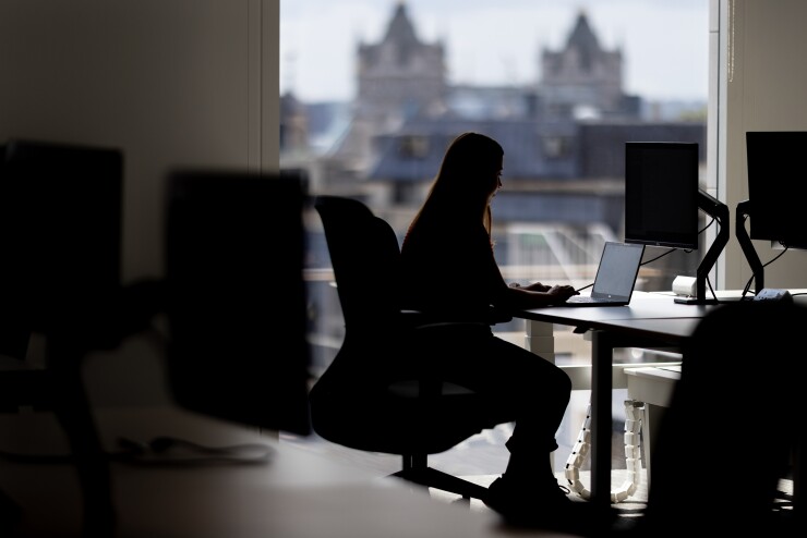 Woman sitting alone at her desk