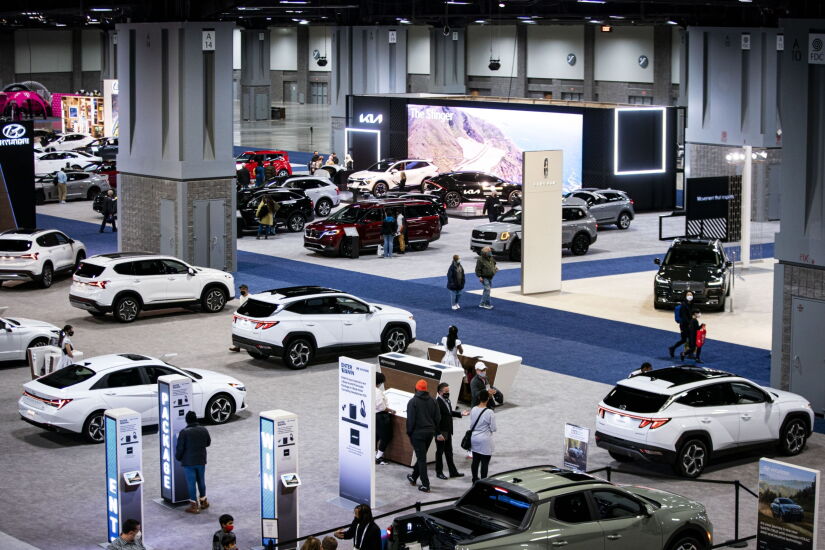 Attendees walk through the Washington Auto Show in Washington, D.C., U.S., on Friday, Jan. 21, 2022. The auto show, designated as one of the nation's top five auto shows by the International Organization of Motor Vehicle Manufacturers, runs from January 21-30. Photographer: Al Drago/Bloomberg