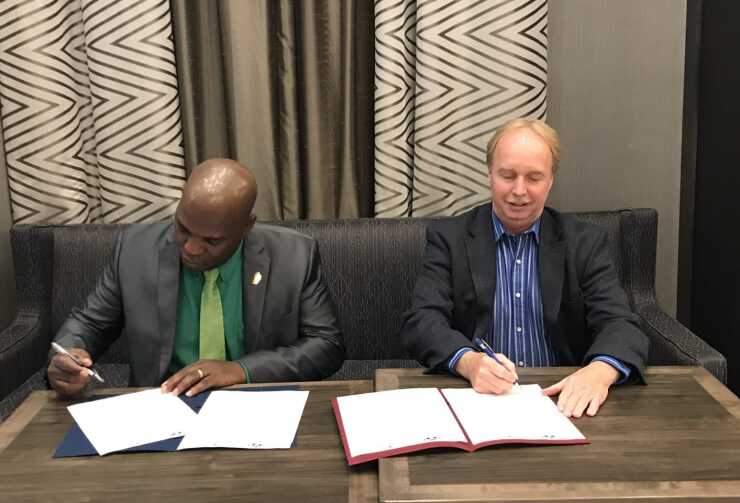 From left: Phoenix Belfield, general manager of the Dominica Co-operative Societies League Ltd., and John McKenzie, president of the Indiana Credit Union League, sign an agreement to increase cooperation between the two organizations by sharing best practices and more.