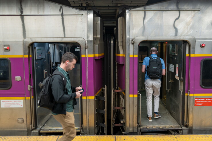 Passengers board an MBTA Commuter Rail train.