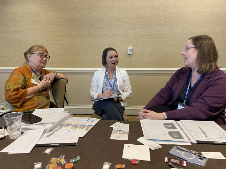 From left to right, Women's Alliance of Financial Advisors board member and mentor Judith McGee, a retired planner, speaks with mentee Ann Austin, a branch manager and financial advisor in the Winder, Georgia-based office of Raymond James, and mentor Traci Richmond, a branch manager and financial advisor with Bethesda, Maryland-based independent advisory practice The Meakem Group.