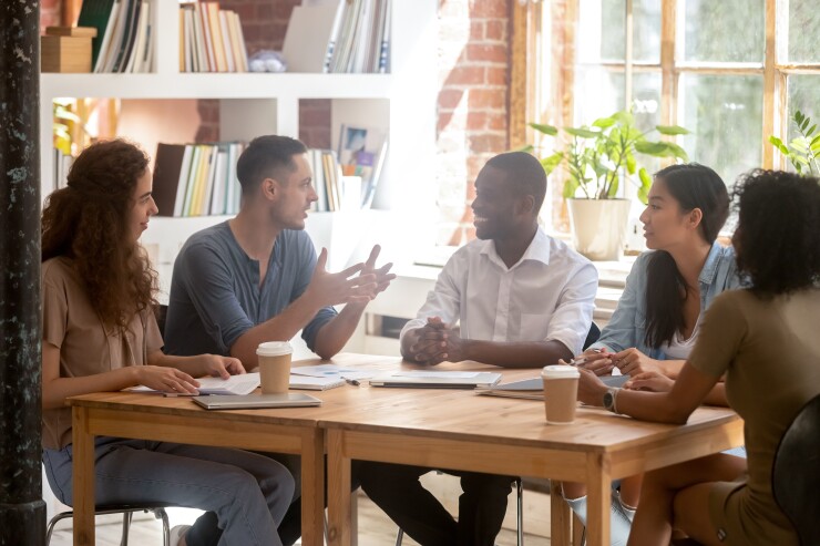Interns working at a table.