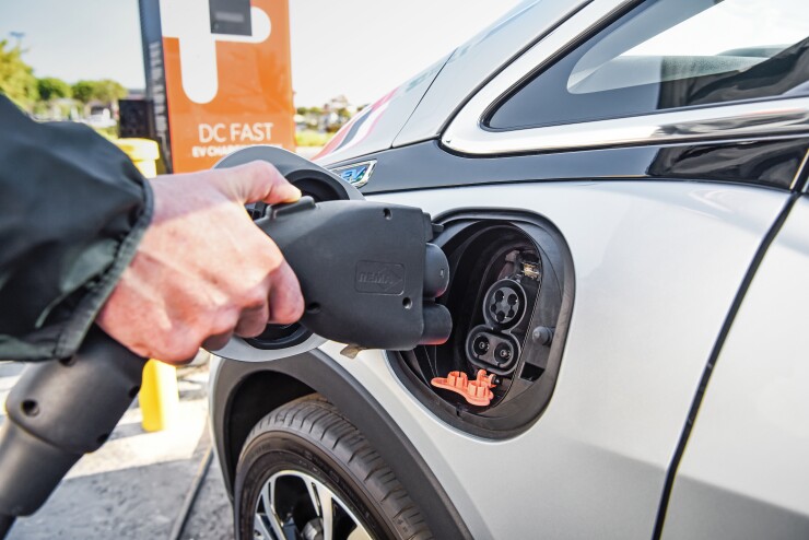 Driver prepares to charge an electric Chevrolet Bolt