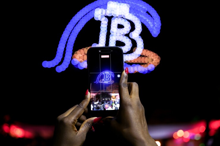 A picture of drones forming the bitcoin 'B' symbol.