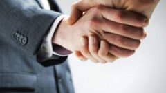 A close up of two people shaking hands.