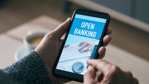 Open banking graphic on a phone that a person is holding