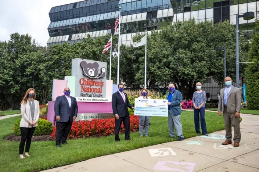 Credit union representatives present a check at Children's National Medical Center in Washington