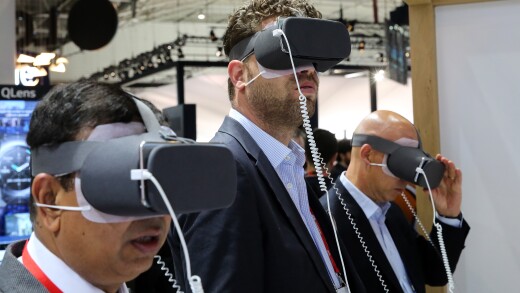 A trio of users test out VR headsets at a convention