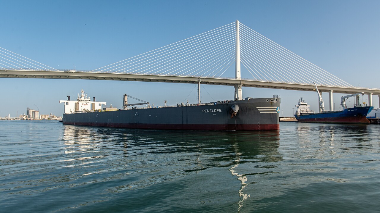 A tanker sails under the harbor bridge in Corpus Christi, Texas, a city facing water shortages that have driven negative rating actions.