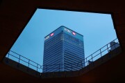 Logos sit illuminated on the HSBC headquarter skyscraper offices in the Canary Wharf business, financial and shopping district in London.