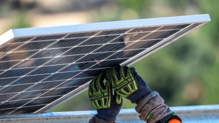 Contractors install solar panels.