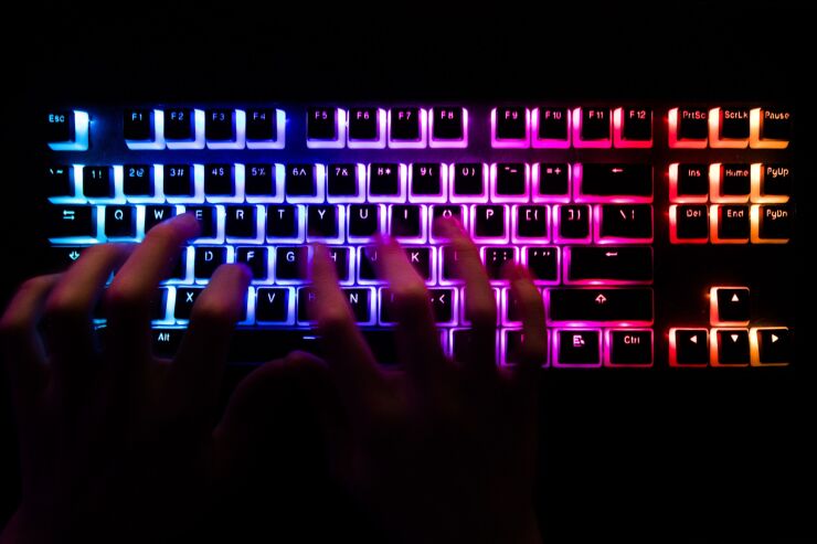 A man typing on a back lit computer keyboard. Photographer: Chris Ratcliffe/Bloomberg