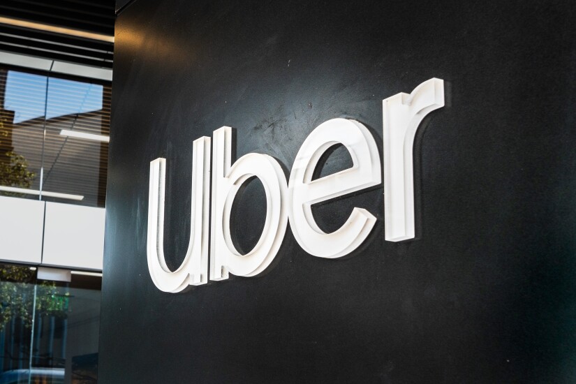 An Uber sign at the San Francisco headquarters, white letters on an all-black wall.
