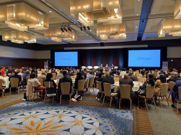 Hundreds of attendees seated at tables at the Association of African American Financial Advisors 2022 Vision conference look on during a panel sponsored by JPMorgan Chase