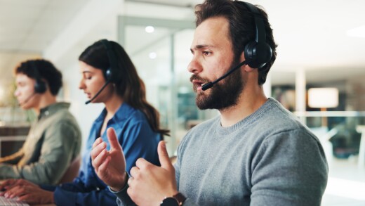 Man, call center and discussion with headset at office, contact us or explain for customer service solution. Person, agent and consultant with talk, advice and info for problem solving at workplace