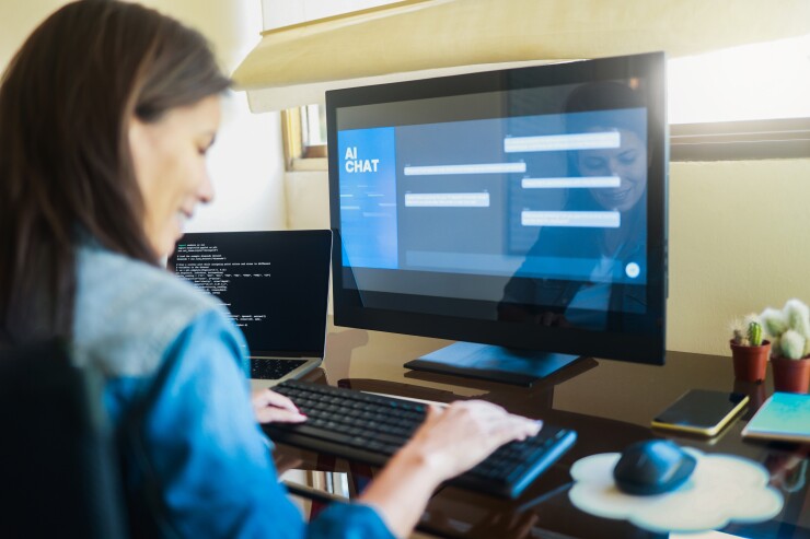 Woman typing into AI chat program on computer