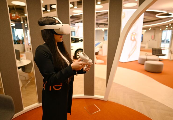An employee wears a Meta Platforms Inc. Oculus Quest 2 virtual reality (VR) headset to demonstrate an immersive experience of BPI banking services inside the Banco BPI SA ‘All in One’ concept bank branch in Lisbon, Portugal, on Monday, April 17, 2023. The Portuguese government forecasts GDP growth of 1.8% for 2023, Finance Minister Fernando Medina said at a news conference about the country’s stability program. Photographer: Zed Jameson/Bloomberg