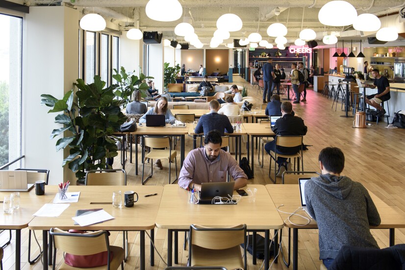 Members work on laptop computers in a common room at the Embarcadero WeWork Cos Inc. offices in San Francisco.