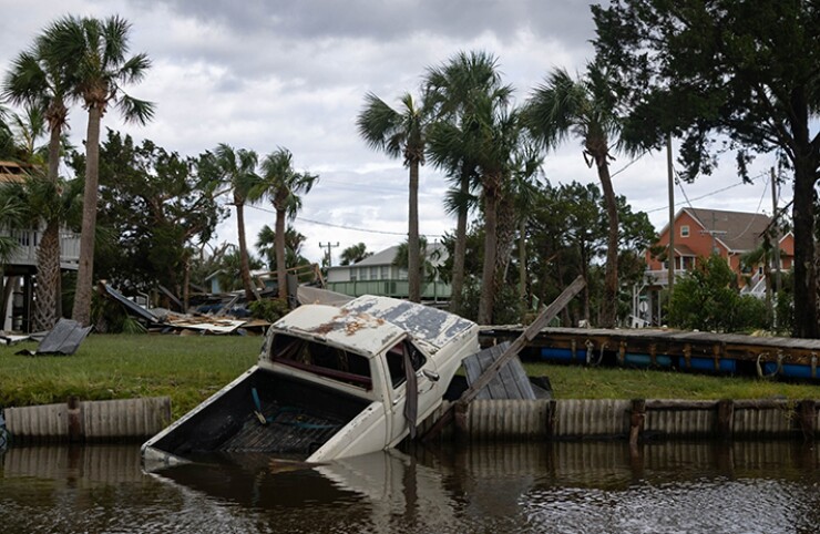 A truck lies partially submerged in the bay following Hurricane Idalia hit Horseshoe Beach, Florida, on Wednesday.