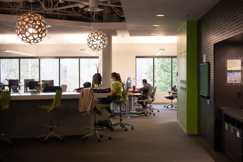 Employees work inside Building 21 at the Microsoft Campus in Redmond, Washington, U.S., on Thursday, March 3, 2022. Microsoft Corp. has begun calling employees back to its headquarters in recent weeks, but its return-to-office strategy hinges on hybrid work. Photographer: Chona Kasinger/Bloomberg