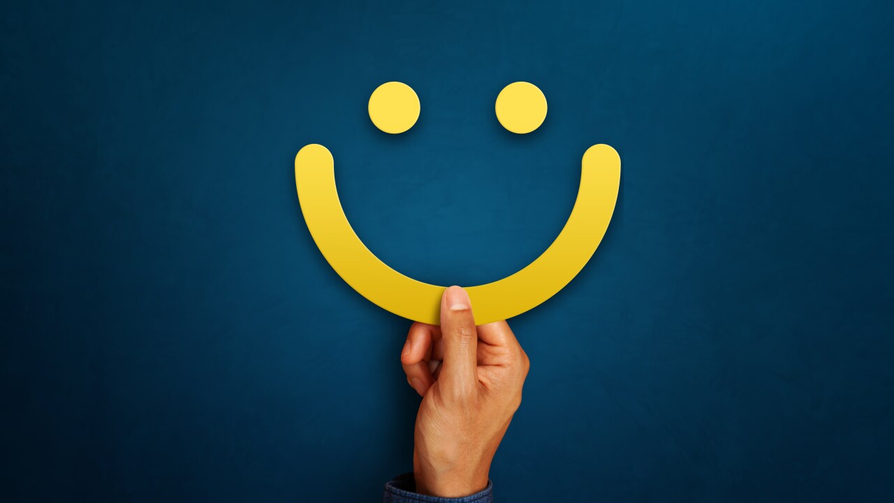 Hand of client show a feedback with smiley face sign. Service ra