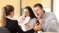Angry couple claiming and shouting to an office worker