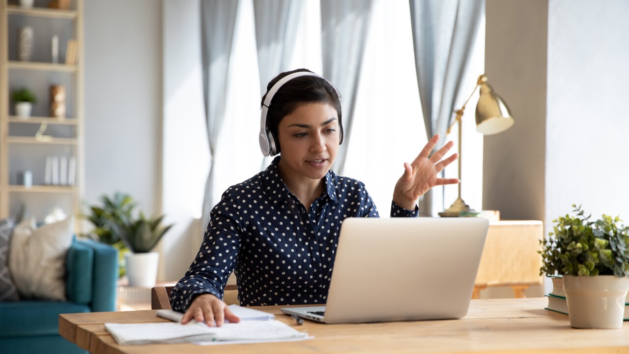 Indian student wear headphones use laptop e-learning remotely by videocall