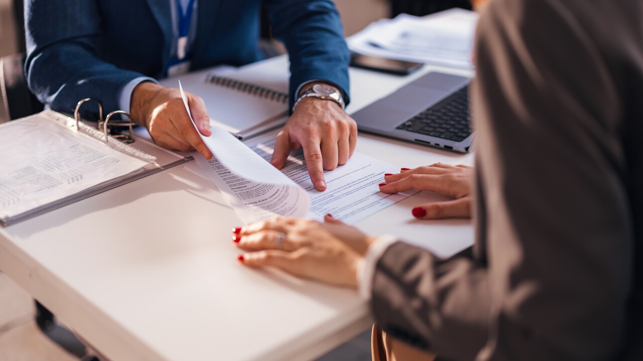 The real estate agent closes the deal with the client and they sign the contract.