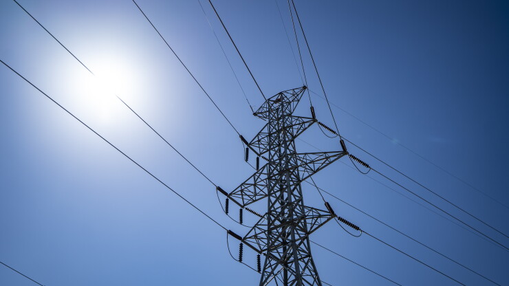 Electrical transmission tower against blue sky