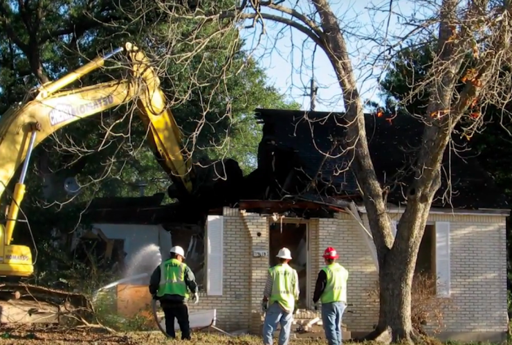 Crews demolish a home in a flood zone in Harris County.