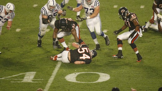 Brian Urlacher of the Chicago Bears, No. 54, reaches for a fumble during Super Bowl XLI