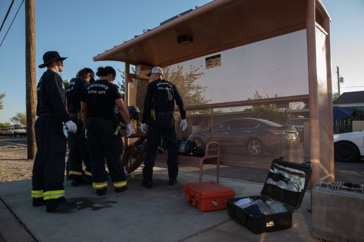Firefighters in Phoenix administer fluids to a resident having trouble breathing July 20 during a heat wave.