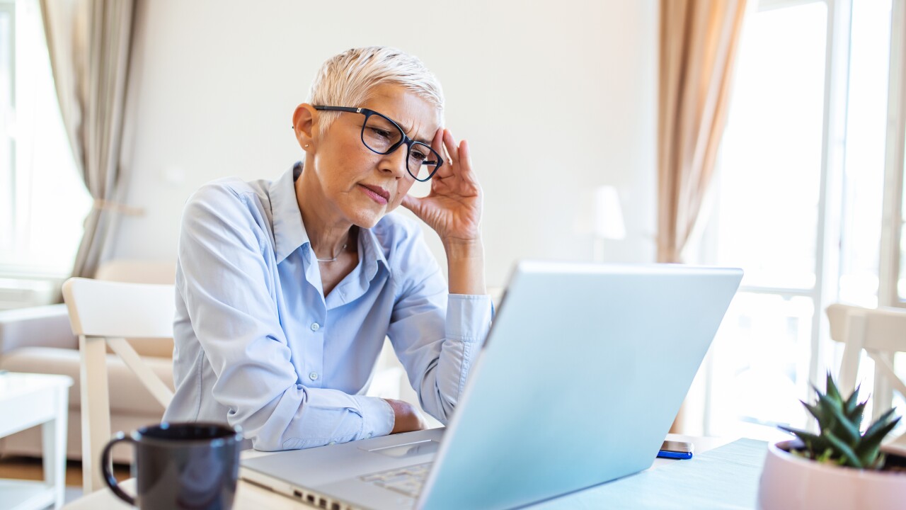 Older woman in front of her computer looking concerned