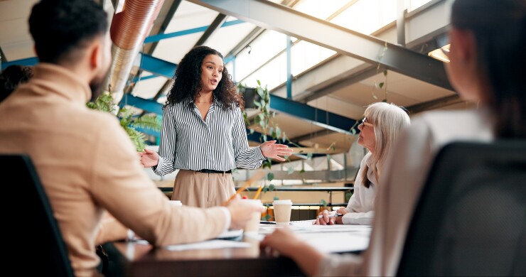 Woman speaking to group of employees