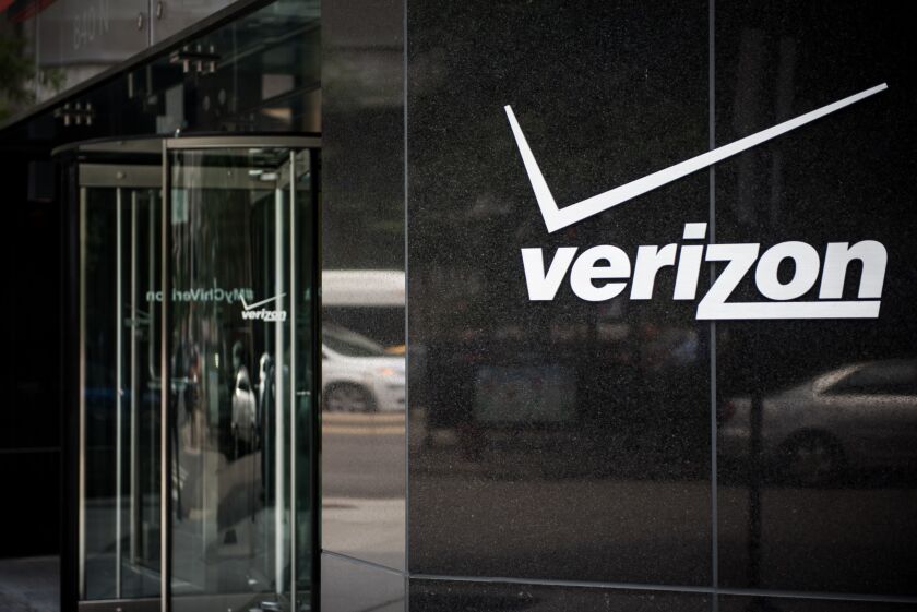 Signage sits on the exterior of a Verizon store in downtown Chicago.