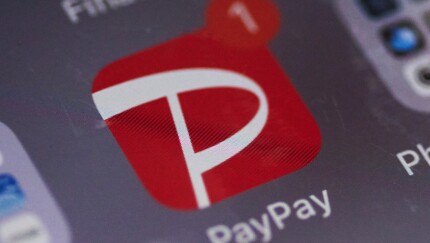 Close-up of the PayPay app icon on a smartphone screen, featuring a white "P" on a red background with one notification.