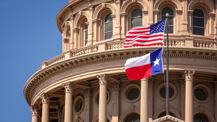 American and Texas Flags Flying at the Texas State Capitol Building in Austin