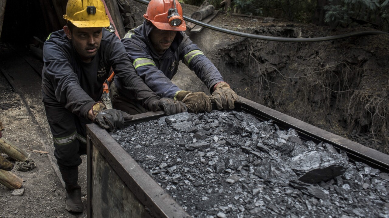 Miners push a wagon of coal outside a mine in Cucunuba, Cundinamarca Department, Colombia, on Friday, July 28, 2017. Colombia is set to produce a record of more than 90 million tons of the fossil fuel this year, its biggest export after oil. Colombia continues to bet on coal, even as global demand tapers off because the world is switching to cleaner fuels. Photographer: Nicolo Filippo Rosso/Bloomberg