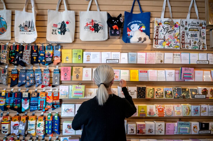 A worker arranges greeting cards at a store in San Francisco.