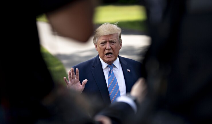 U.S. President Donald Trump speaks to members of the media before boarding Marine One on the South Lawn of the White House in Washington, D.C.