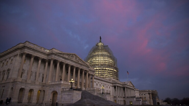 Capitol building with scaffolding at sunset