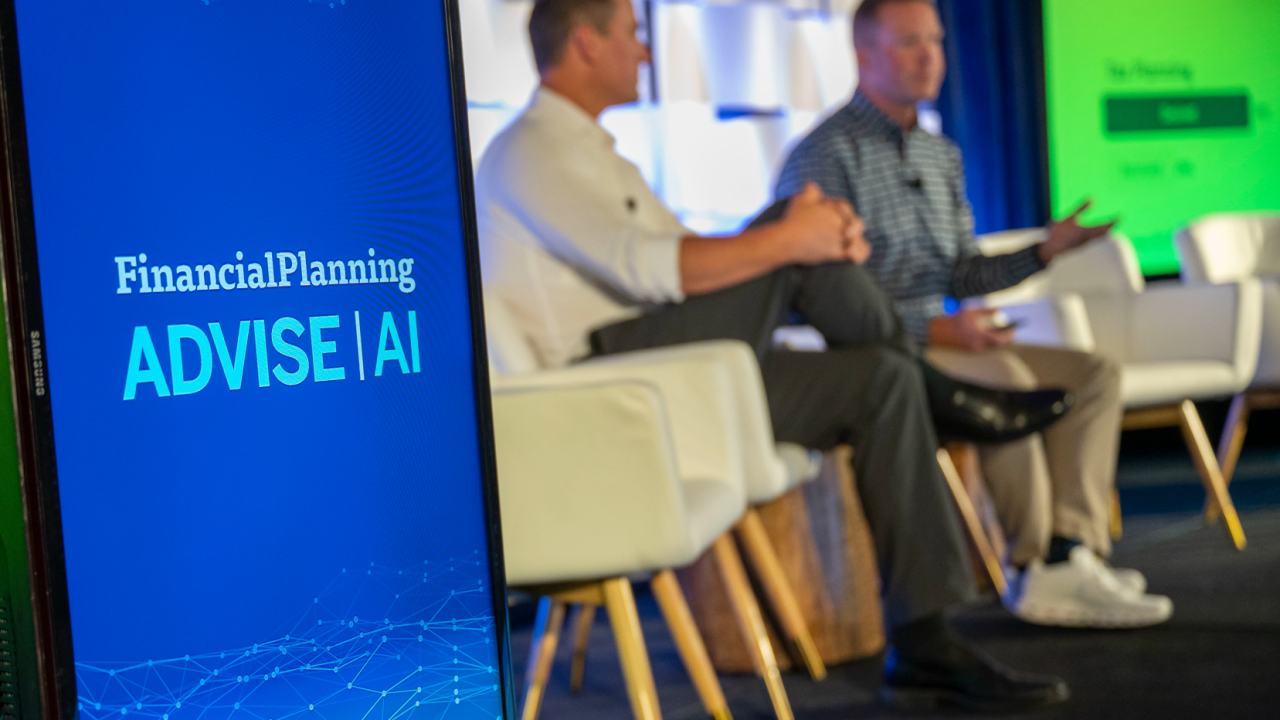 The state at an ADVISE AI event with a logo and two men speaking to an audience.
